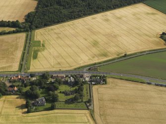 General oblique aerial view of the cropmarks of the field boundary and the modern feature looking across Glasmuir and the Old Parish Church, taken from the N.