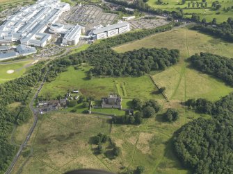 Oblique aerial view of Craigmillar Castle with the Royal Infirmary of Edinburgh, Little France, beyond, taken from the NNW.