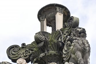 Carved tripod finial with griffons. Detail