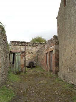 View from SSW of yard and buildings and showing coach recess in gable end of house.