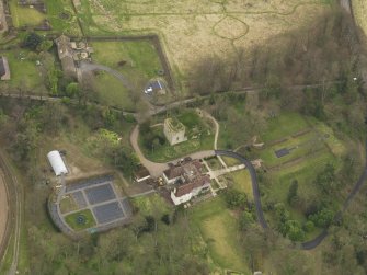 Oblique aerial view centred on the house with the tower-house adjacent, taken from the WNW.