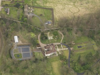 Oblique aerial view centred on the house with the tower-house adjacent, taken from the W.