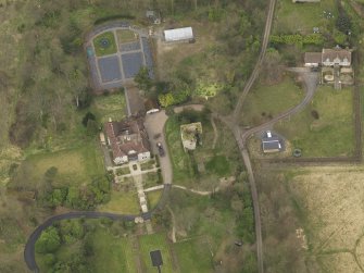Oblique aerial view centred on the house with the tower-house adjacent, taken from the SSE.