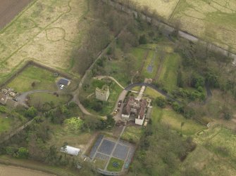 Oblique aerial view centred on the house with the tower-house adjacent, taken from the NNW.
