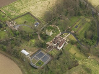 Oblique aerial view centred on the house with the tower-house adjacent, taken from the NW.
