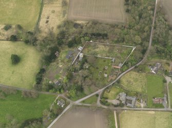 Oblique aerial view centred on the tower and remains of the palace with the walled gardens adjacent, taken from the NE.