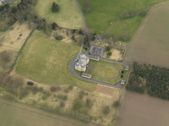 Oblique aerial view centred on the country house with the garden adjacent, taken from the SW.