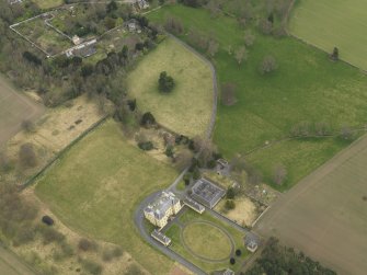 Oblique aerial view centred on the country house with the garden adjacent, taken from the S.