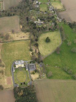 Oblique aerial view centred on the country house with the garden adjacent, taken from the SSE.