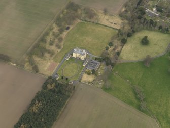 Oblique aerial view centred on the country house with the garden adjacent, taken from the SE