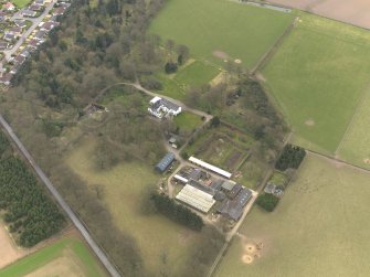 Oblique aerial view centred on the country house with the tower-house adjacent, taken from the NW.