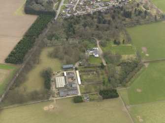 Oblique aerial view centred on the country house with the tower-house adjacent, taken from the WSW.