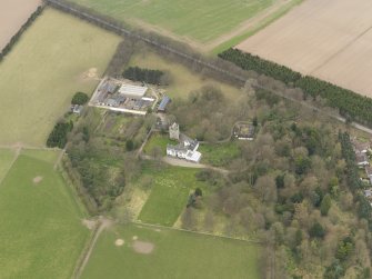 Oblique aerial view centred on the country house with the tower-house adjacent, taken from the SSE.