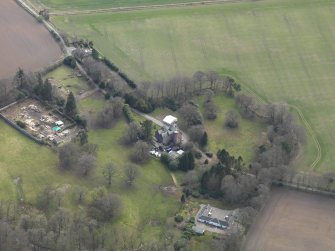 Oblique aerial view centred on the country house with the walled garden and stables adjacent, taken from the NNW.