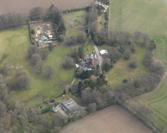 Oblique aerial view centred on the country house with the walled garden and stables adjacent, taken from the NW.