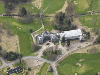 Oblique aerial view centred on the country house (hotel),  taken from the NE.