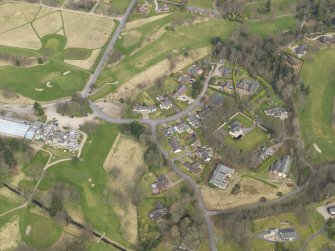 Oblique aerial view centred on the stables with the country house (hotel) adjacent,  taken from the SSW.