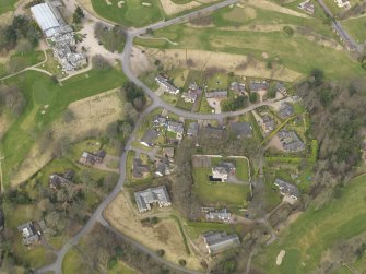 Oblique aerial view centred on the stables with the country house (hotel) adjacent,  taken from the SSE.