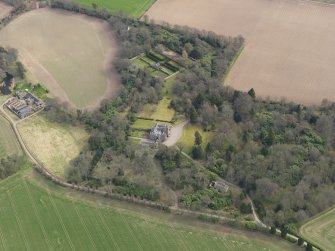 Oblique aerial view centred on the country house with the walled garden adjacent, taken from the NW.