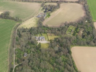 Oblique aerial view centred on the country house with the walled garden adjacent, taken from the SW.