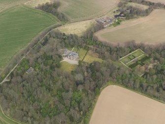 Oblique aerial view centred on the country house with the walled garden adjacent, taken from the SSW.