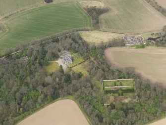 Oblique aerial view centred on the country house with the walled garden adjacent, taken from the S.