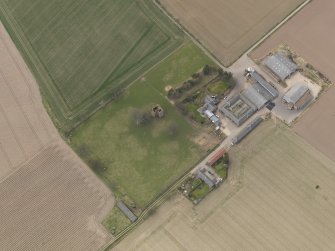 General oblique aerial view centred on the remains of the tower-house with the farmstead adjacent, taken from the SE.