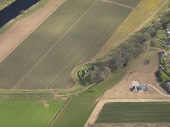 Oblique aerial view centred on the remains of the church with the burial ground adjacent, taken from the WSW.