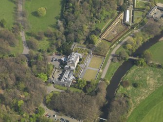 Oblique aerial view centred on the house, taken from the W.