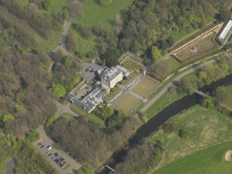 Oblique aerial view centred on the house, taken from the WSW.