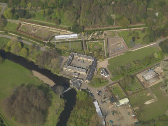 General oblique aerial view centred on the stable block, taken from the S.