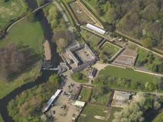 General oblique aerial view centred on the stable block, taken from the SE.