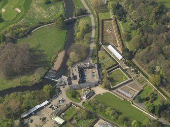 General oblique aerial view centred on the stable block, taken from the SE.