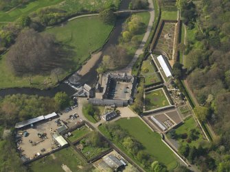 General oblique aerial view centred on the stable block, taken from the E.