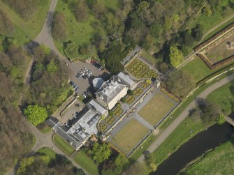 General oblique aerial view centred on the house, taken from the SW.
