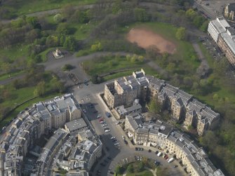 Oblique aerial view centred on the fire damaged tenement, taken from the SE.