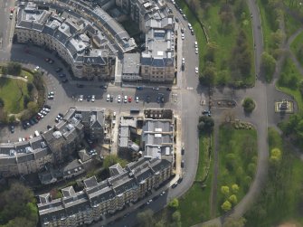 Oblique aerial view centred on the fire damaged tenement, taken from the NNE.