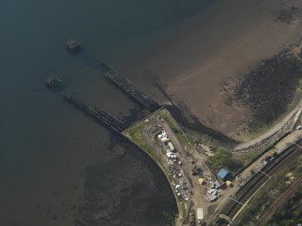Oblique aerial view centred on the remains of the pier, taken from the E.