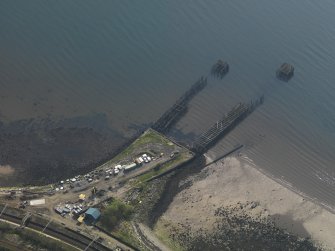 Oblique aerial view centred on the remains of the pier, taken from the N.