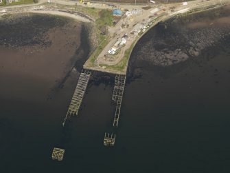 Oblique aerial view centred on the remains of the pier, taken from the WSW.