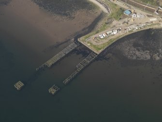 Oblique aerial view centred on the remains of the pier, taken from the SW.