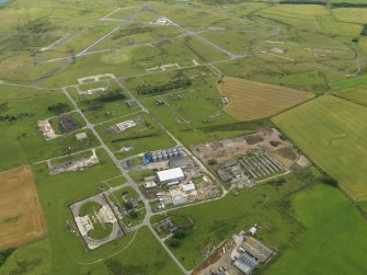 General oblique aerial view centred on the airfield with the farmstead and farmhouse adjacent, taken from the SSW.