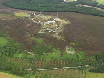 Oblique aerial view centred on the scatter station with the 'stag' adjacent, taken from the SE.