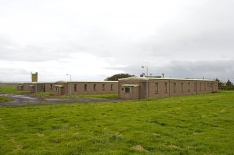 View from NE of single quarters transit huts.