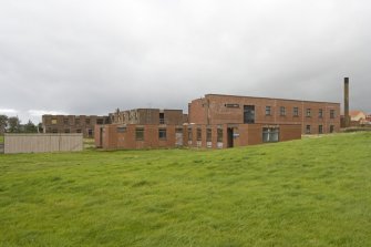 General view from SE of the two large transit accommodation blocks.