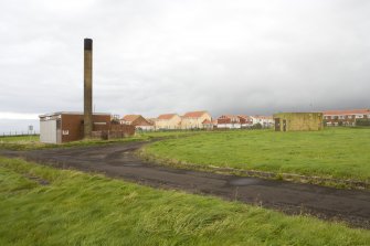 General view from SE of boiler house with domestic accommodation in the background.