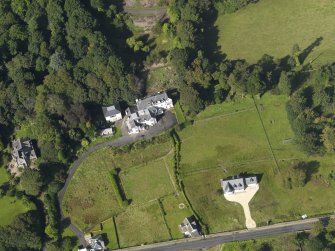 Oblique aerial view centered on the house, taken from the SE.