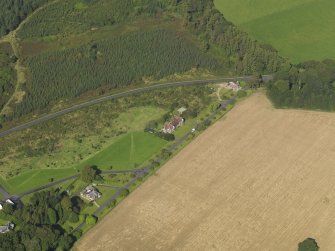 General oblique aerial view centred on the schoolhouse, taken from the SE.