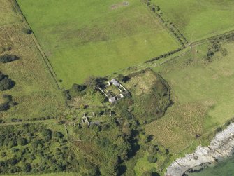 Oblique aerial view centred on the two farmsteads and the site of the chapel (middle right), taken from the ESE.