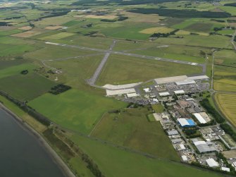 General oblique aerial view centred on the airfield with the techncal site (terminal) adjacent, taken from the WNW.